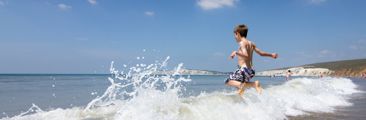 Child running into the sea